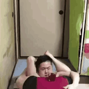 a man and a woman are doing exercises on a yoga mat in a room .