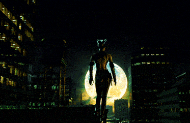 a silhouette of a woman standing in front of a full moon in a city
