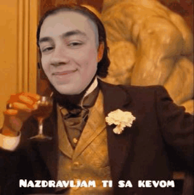 a man in a suit and tie is holding a glass of wine in front of a statue .