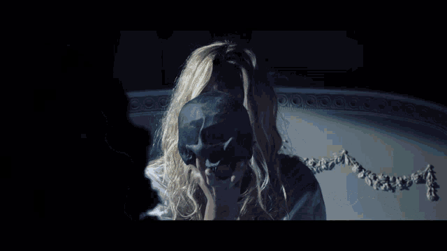 a woman with a skull mask on her face