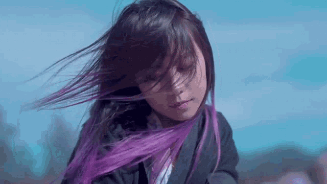 a girl with purple hair is wearing a suit and tie