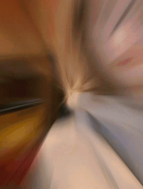 a blurred image of a person 's face with a light coming out of it