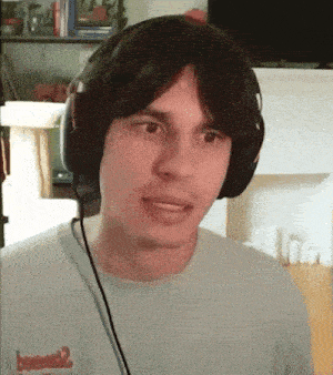 a man wearing headphones and a t-shirt that says ' bomber ' on it