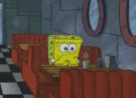spongebob squarepants is sitting at a table in a diner