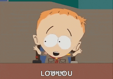 a cartoon character from south park is sitting at a desk and saying lou n'you .