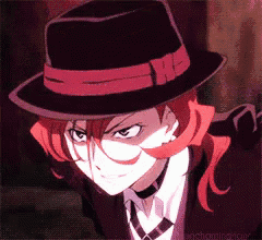 a man with red hair is wearing a black hat