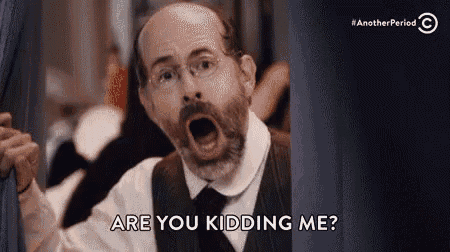 a man with a beard and glasses is making a funny face and asking are you kidding me ?
