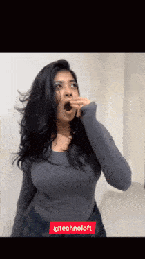 a woman covering her mouth with her hand and the words technoloft behind her