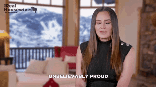 a woman says unbelievably proud in front of a window