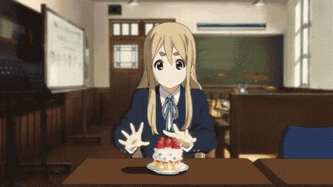 a girl in a school uniform is sitting at a table eating a cake
