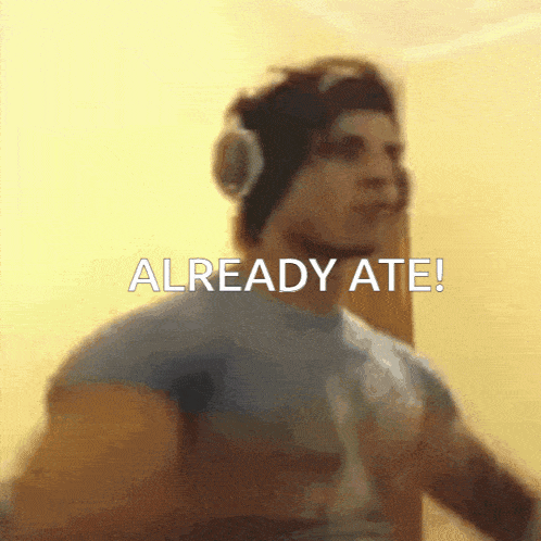 a man wearing headphones says " already ate " on the screen