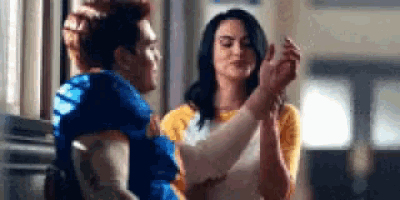 a man and woman are dancing together in a room .