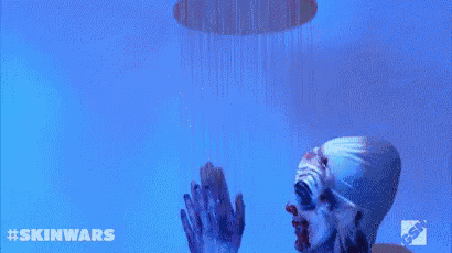 a clown is clapping his hands in front of a blue background with #skinwars written on it