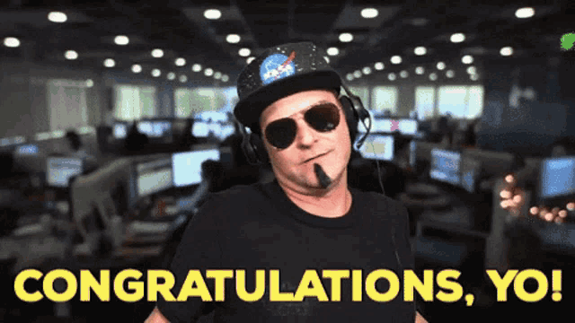 a man wearing a nasa hat and sunglasses says congratulations