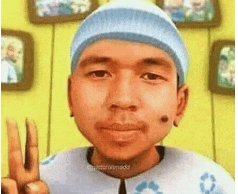 a man wearing a blue hat and a white shirt is giving a peace sign .