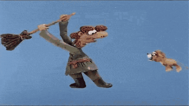 a cartoon of a witch flying with a broom and a dog