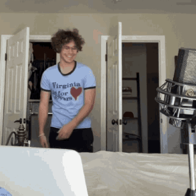 a man wearing a blue virginia for lovers shirt