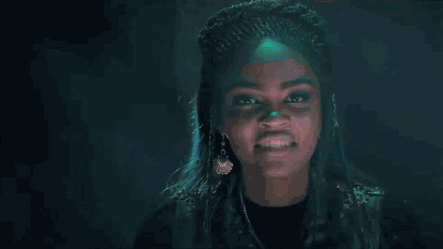 a close up of a woman 's face with a green light shining on it .