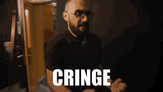 a man with a beard and glasses stands in front of a door with the word cringe on it