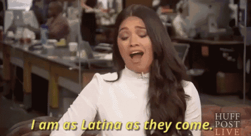 a woman is sitting on a couch and talking about being a latina .