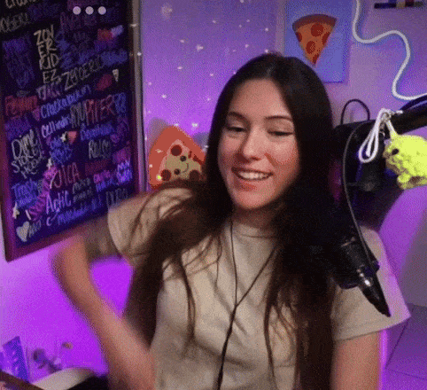 a woman wearing headphones is smiling in front of a microphone in front of a sign that says ' pizza ' on it