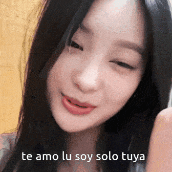 a close up of a woman 's face with te amo lu soy solo tuya written below her