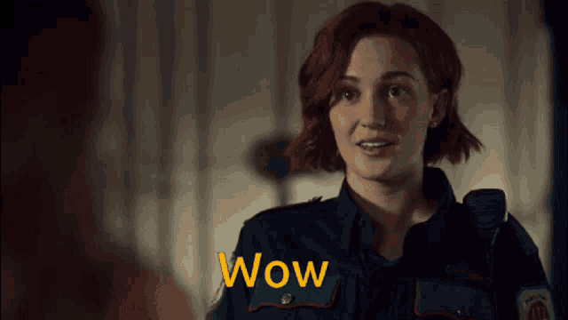 a woman with red hair is wearing a uniform that says wow on it