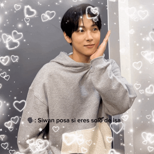 a man in a grey hoodie is surrounded by hearts and the caption siwan posa si eres solo de isa