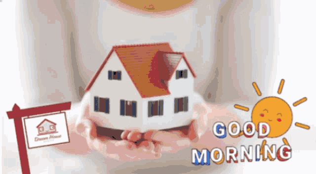 a person is holding a model house in their hands with the words good morning written below it