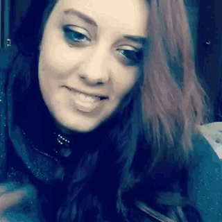 a close up of a woman 's face with long red hair