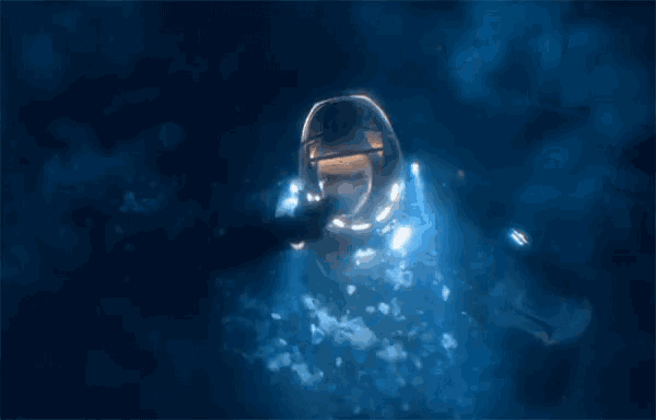 a person in a helmet is swimming in a body of water