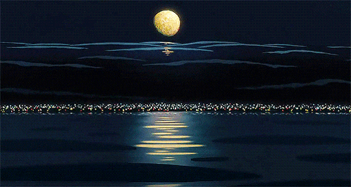 a full moon rises over a body of water at night