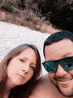 a man and a woman wearing sunglasses are posing for a picture together