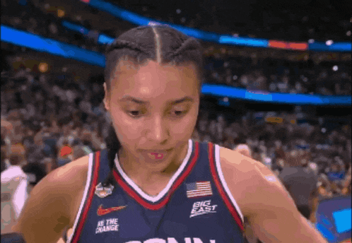 a woman wearing a jersey that says big east