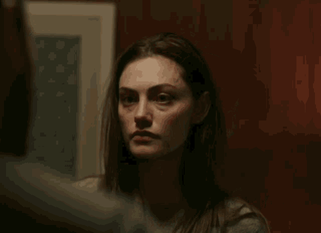 a woman in a gray sweater looks at a man