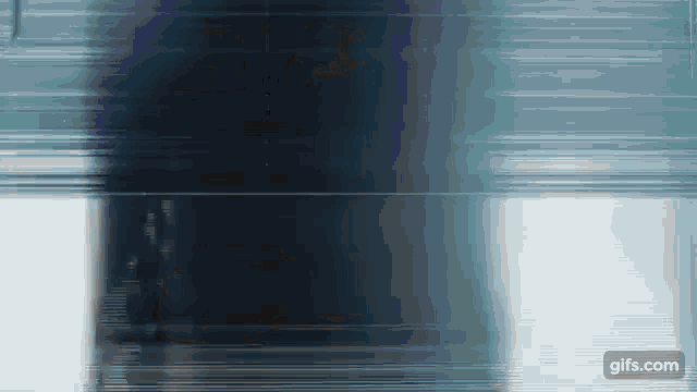 a gif of a person walking in a dark room