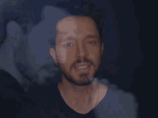 a close up of a man 's face with another man 's face in the background