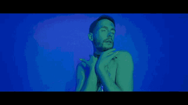 a man squatting down with a woman on his back