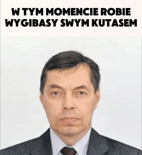 a man in a suit and tie with the words w tym momencie robie wygibasy swym kutasem written above him