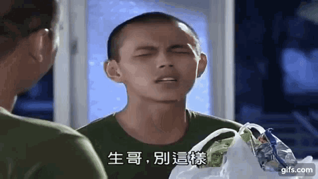 a man in a green shirt is holding a shopping bag and making a funny face