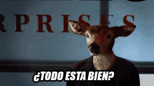 a stuffed deer is standing in front of a sign that says ' rprises '