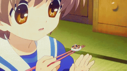 a girl is holding a piece of food with chopsticks in her hand