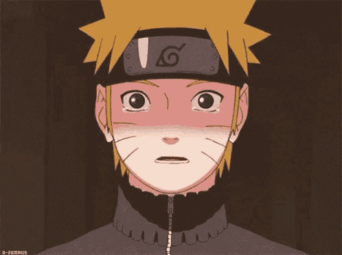 a close up of a cartoon character with a headband on his head and tears running down his face .