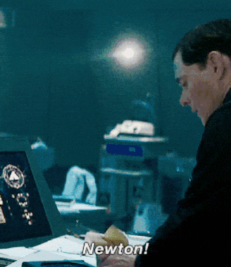 a man sitting in front of a laptop with the words newton written on the screen