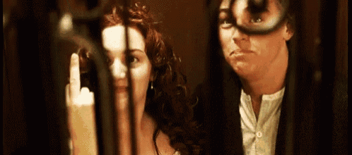 a man and a woman are standing next to each other in a room .