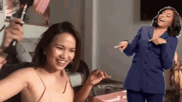 a woman in a blue suit is standing next to another woman