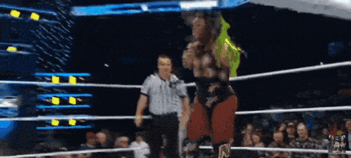 a wrestler with the letter n on his pants stands in a ring