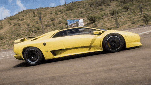 a yellow sports car is driving down a road in the desert