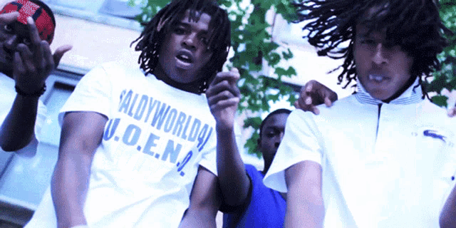 a man wearing a shirt that says saldyworldo u.o.e.n. on it