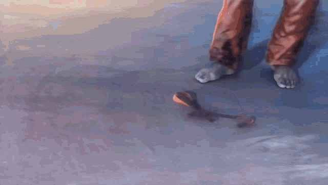 a painting of a person 's feet and a broken shoe on the ground